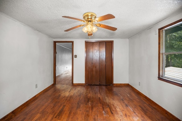 390 County Road 076, Jasper, TX 75951 - unfurnished bedroom with hardwood / wood-style flooring, a textured ceiling, ceiling fan, and baseboards