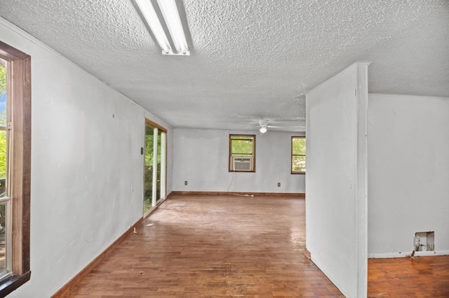 390 County Road 076, Jasper, TX 75951 - unfurnished room with a textured ceiling, ceiling fan, wood finished floors, and cooling unit