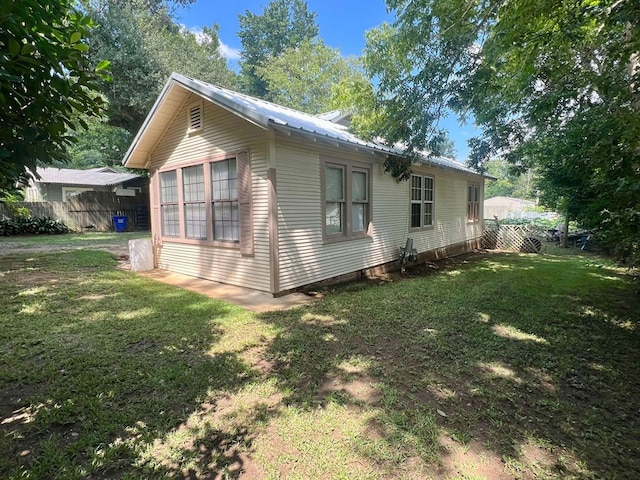 view of side of property featuring a yard