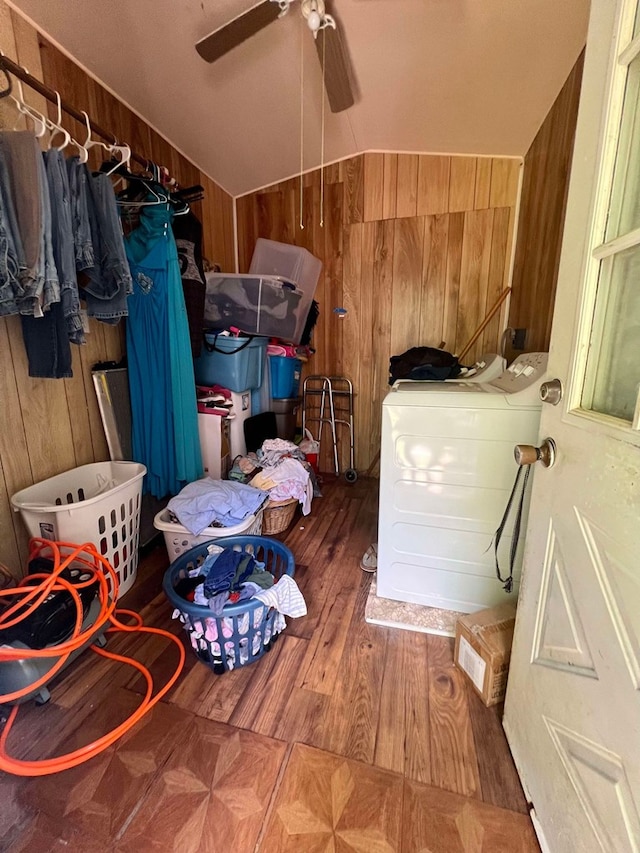 washroom with hardwood / wood-style floors, separate washer and dryer, ceiling fan, and wooden walls