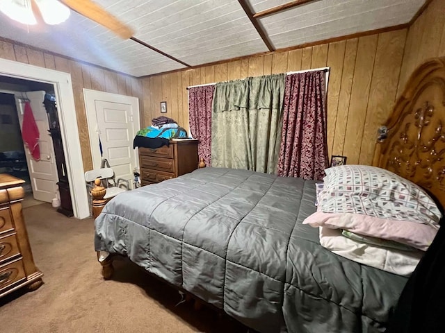 bedroom with wood walls, ceiling fan, and light colored carpet