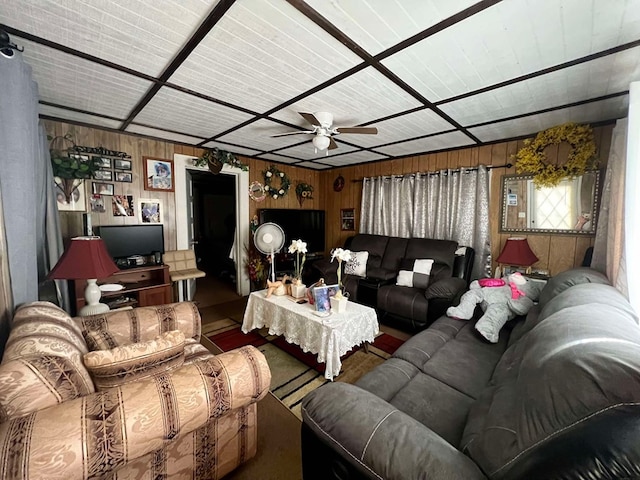 living room with wood walls and ceiling fan