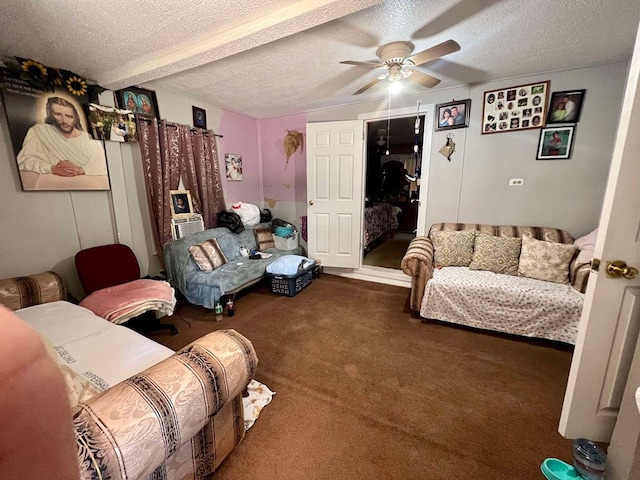 living room with ceiling fan, dark carpet, and a textured ceiling