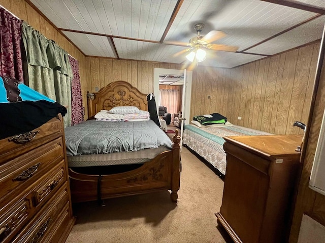 carpeted bedroom featuring ceiling fan, wooden walls, and wood ceiling