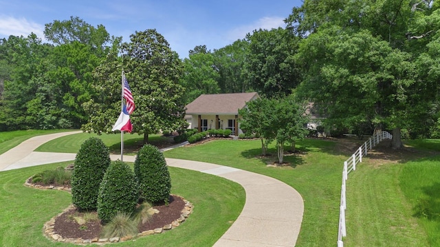 view of home's community with a yard