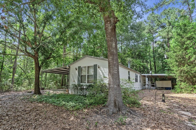 view of side of home with a carport