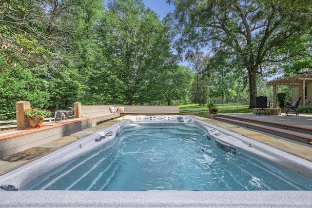 view of swimming pool with a wooden deck