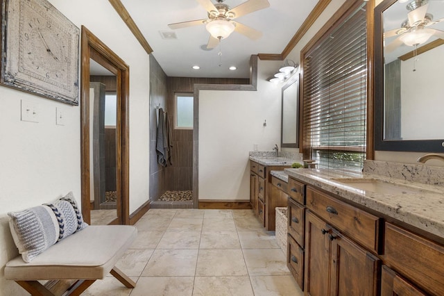 bathroom featuring ceiling fan, tile patterned flooring, tiled shower, vanity, and ornamental molding