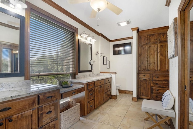 bathroom with vanity, toilet, ceiling fan, and crown molding