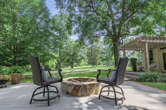 view of patio / terrace featuring a pergola, a wooden deck, and an outdoor fire pit