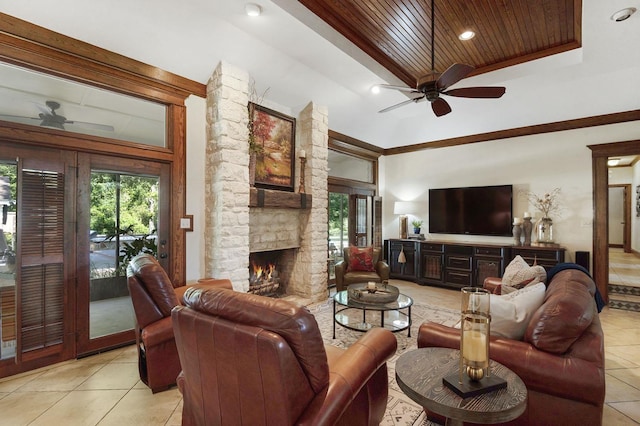 tiled living room featuring a towering ceiling, a stone fireplace, ceiling fan, and wood ceiling