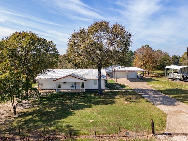 view of front facade featuring a front lawn, a garage, and a carport