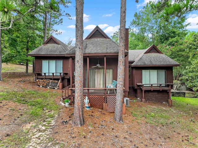 back of property with roof with shingles