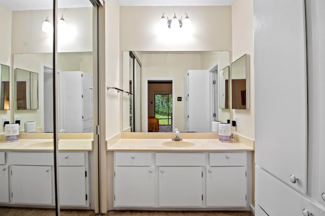 bathroom with two vanities and a sink