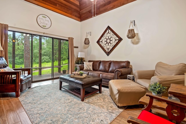 living room with a high ceiling and wood finished floors