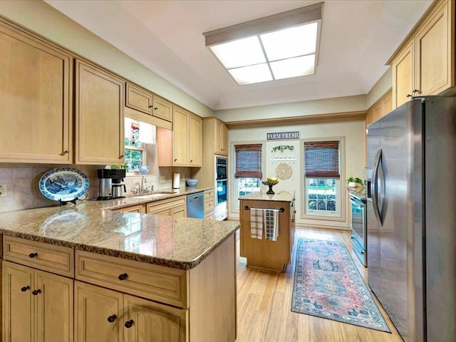 kitchen featuring light hardwood / wood-style floors, light brown cabinetry, sink, and appliances with stainless steel finishes