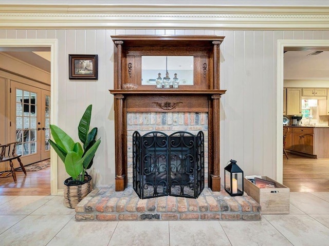 interior space featuring wooden walls, a fireplace, wood-type flooring, and french doors