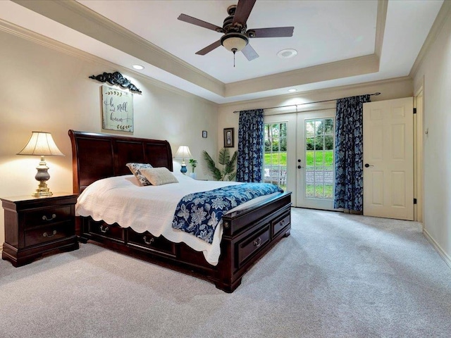 bedroom with access to outside, ceiling fan, a tray ceiling, and light colored carpet