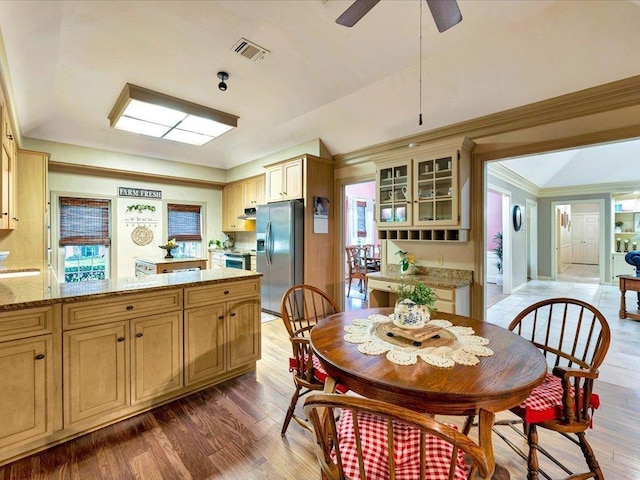 dining room with dark hardwood / wood-style floors, ceiling fan, and ornamental molding