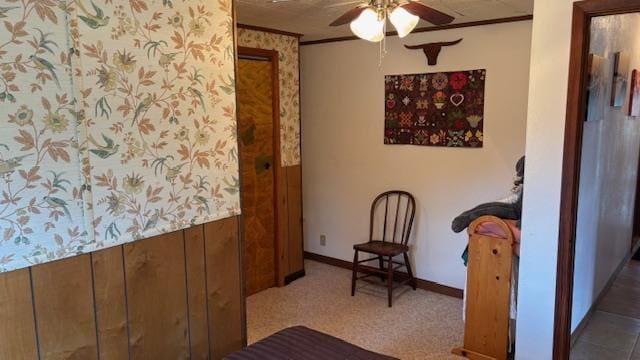 carpeted bedroom featuring ornamental molding and ceiling fan