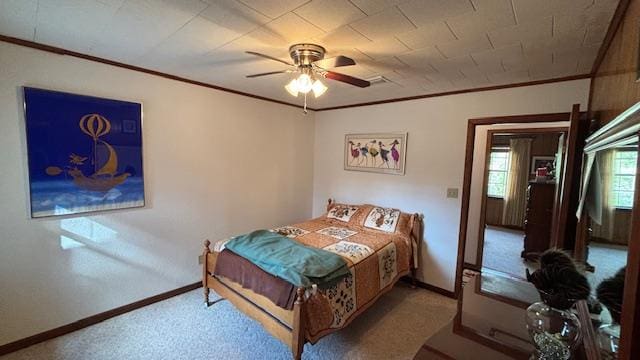 bedroom featuring ceiling fan, ornamental molding, and light carpet