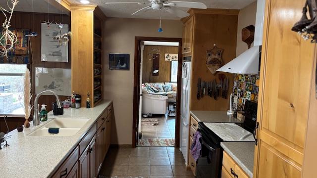 672 Oakhill Rd, Hemphill, TX 75948 - kitchen featuring light countertops, electric range, light tile patterned flooring, ceiling fan, and a sink
