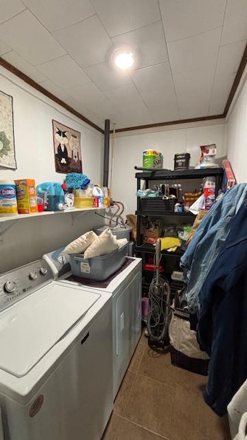 672 Oakhill Rd, Hemphill, TX 75948 - clothes washing area featuring crown molding, tile patterned floors, washer and dryer, and laundry area