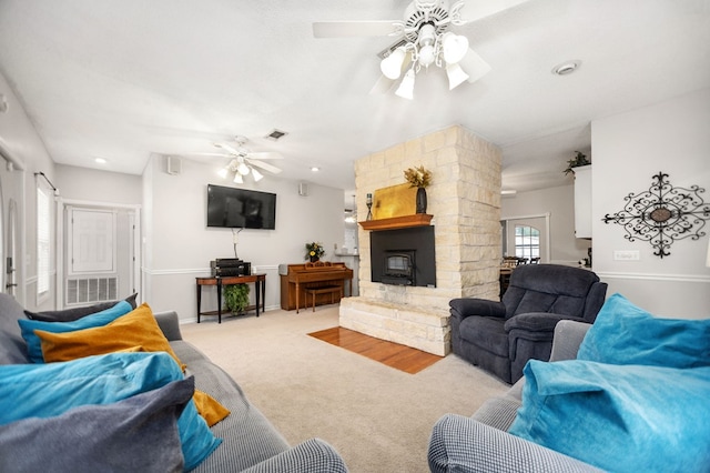 carpeted living area featuring a ceiling fan and visible vents