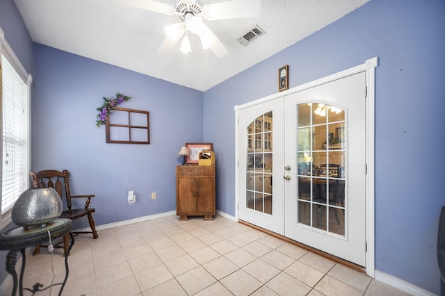 living area featuring visible vents, baseboards, ceiling fan, french doors, and light tile patterned floors