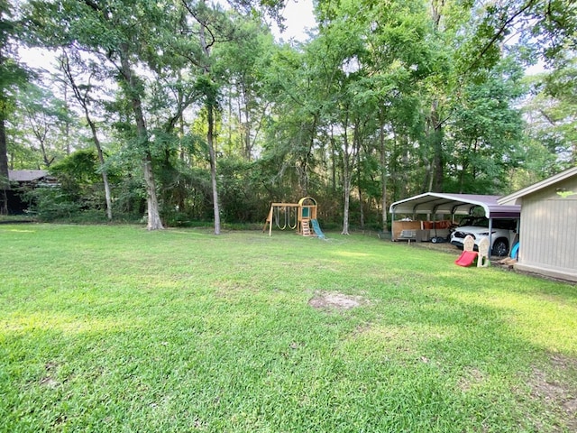 view of yard with a playground and a carport