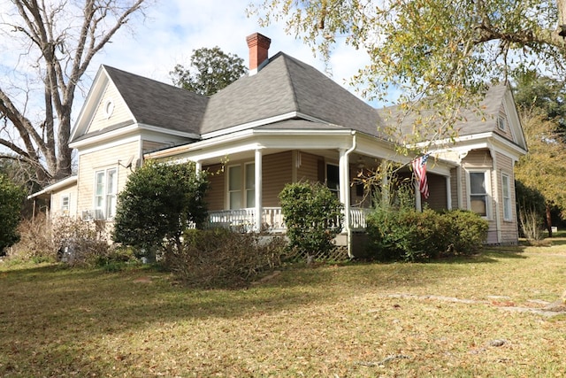 view of property exterior with a lawn and a porch