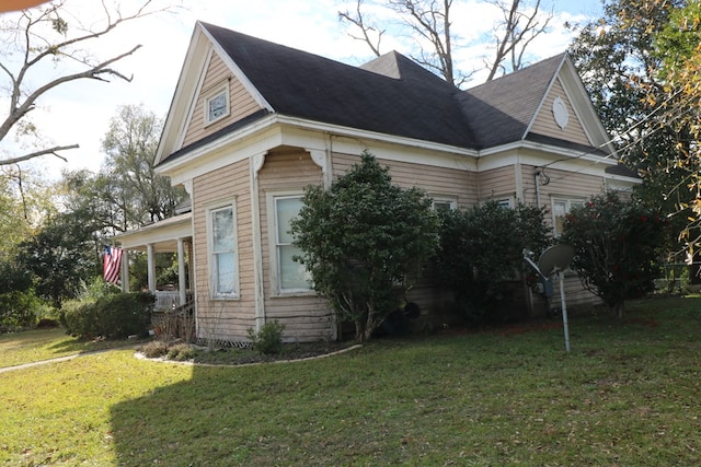 view of property exterior with a yard