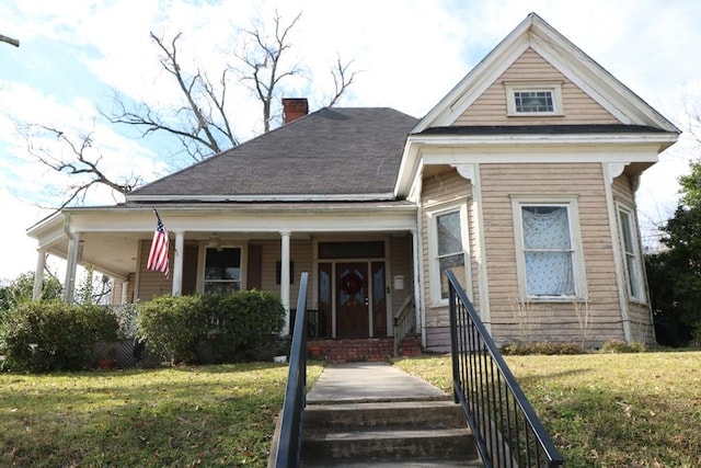 view of front of home with a front lawn and covered porch