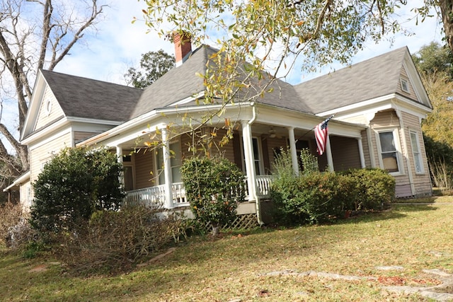 view of front of property with a front yard and a porch