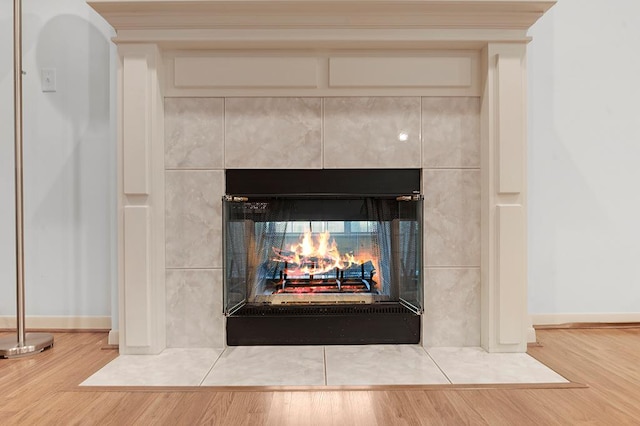 627 Shoreline Dr, Brookeland, TX 75931 - detailed view of wood finished floors, a tiled fireplace, and baseboards