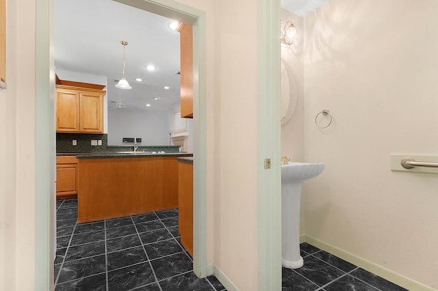 627 Shoreline Dr, Brookeland, TX 75931 - bathroom with baseboards, tasteful backsplash, and a sink