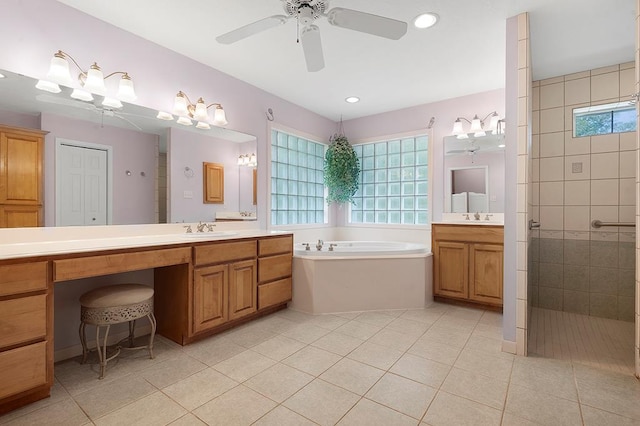 627 Shoreline Dr, Brookeland, TX 75931 - full bathroom featuring a garden tub, tiled shower, two vanities, ceiling fan, and tile patterned floors