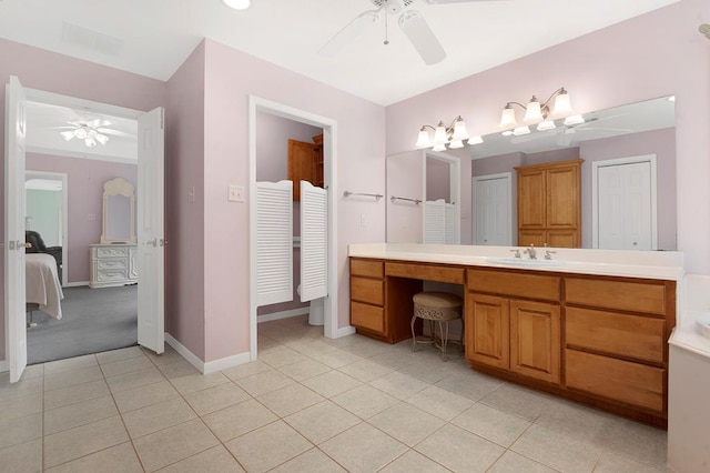 627 Shoreline Dr, Brookeland, TX 75931 - ensuite bathroom with ceiling fan, a closet, vanity, tile patterned flooring, and baseboards