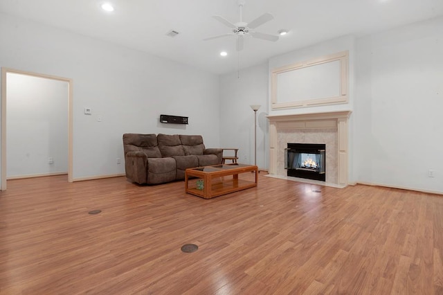 627 Shoreline Dr, Brookeland, TX 75931 - living area featuring light wood-type flooring, a ceiling fan, a high end fireplace, recessed lighting, and baseboards