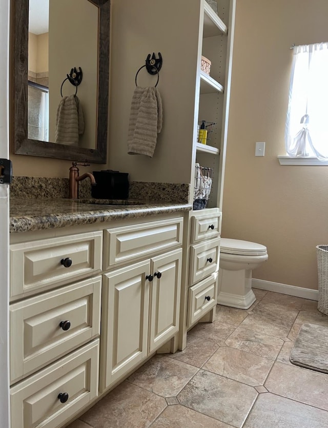 bathroom featuring vanity, toilet, and a shower