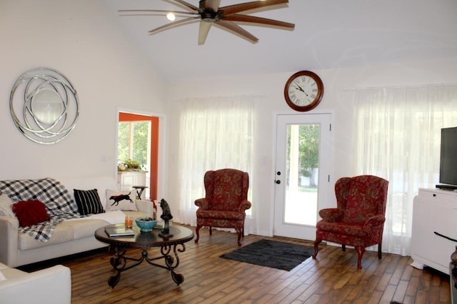 living room featuring ceiling fan, dark hardwood / wood-style flooring, and vaulted ceiling