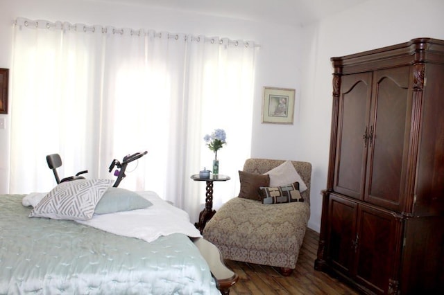 bedroom with hardwood / wood-style floors and multiple windows