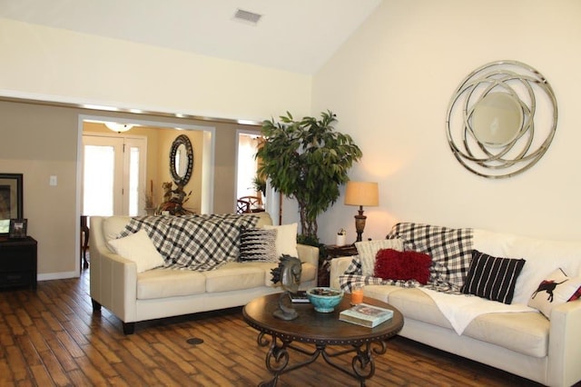 living room with dark hardwood / wood-style flooring and high vaulted ceiling