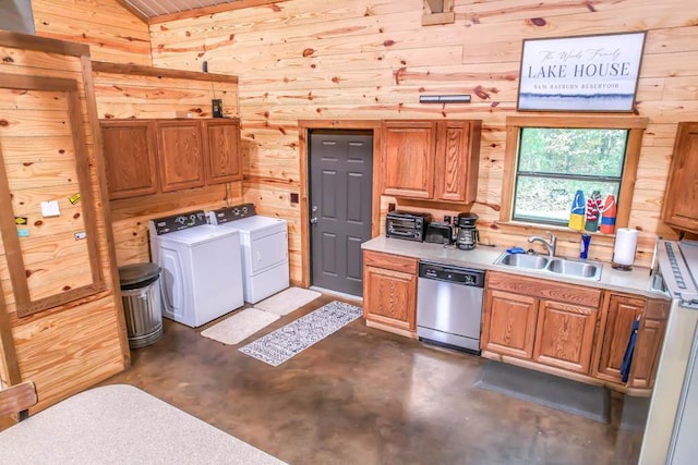 kitchen featuring washer and clothes dryer, wood walls, dishwasher, and sink