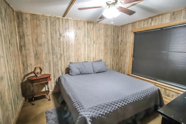 carpeted bedroom featuring ceiling fan and wooden walls