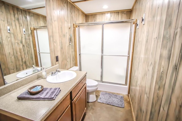 bathroom featuring vanity, toilet, walk in shower, and wooden walls