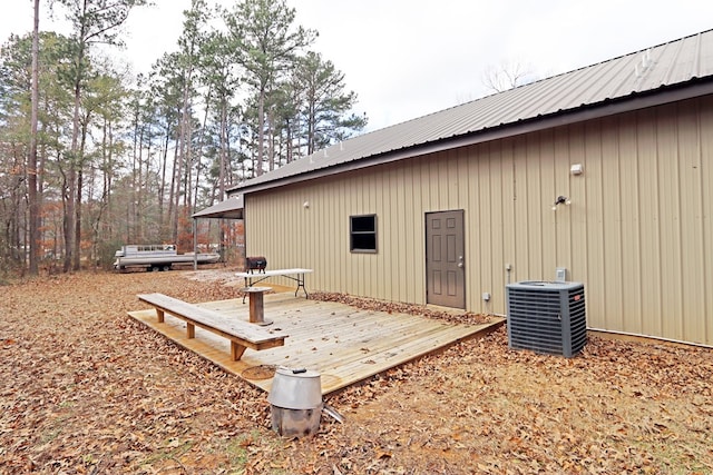 view of side of home with cooling unit and a deck