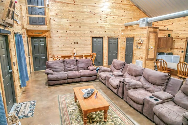 living room featuring wood ceiling, wooden walls, high vaulted ceiling, and washer and dryer