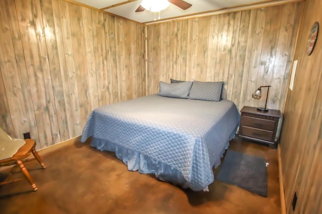 bedroom with ceiling fan and wooden walls