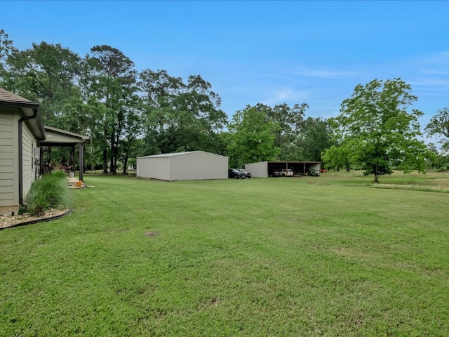 3274 Cc Rd, Diboll, TX 75941 - view of green lawn featuring a pole building, an outdoor structure, and a carport